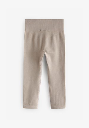 Béžové žebrované legíny s širokým elastickým pasem, vyrobené z pružného materiálu, s hladkým povrchem a obepínajícím střihem.