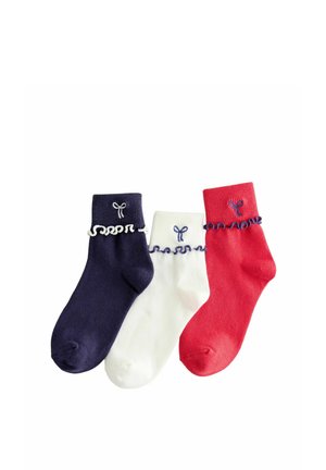 Three ankle socks in navy, white, and red with ruffled cuffs and small embroidered bow designs above the ruffles on a white background.
