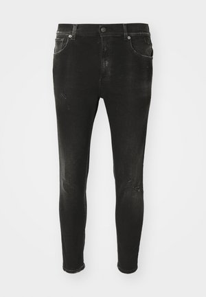 Zwarte skinny jeans van denim, met een vervaagde afwerking en versleten details aan de voorkant. Standaard taille met riemlussen en zakken.