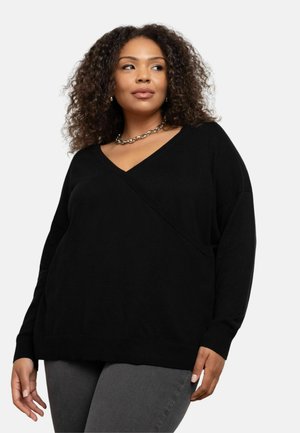 Czarny sweter V-neck z krzyżującym się przodem, długimi rękawami i luźnym krojem, wykonany z miękkiego, teksturowanego materiału.