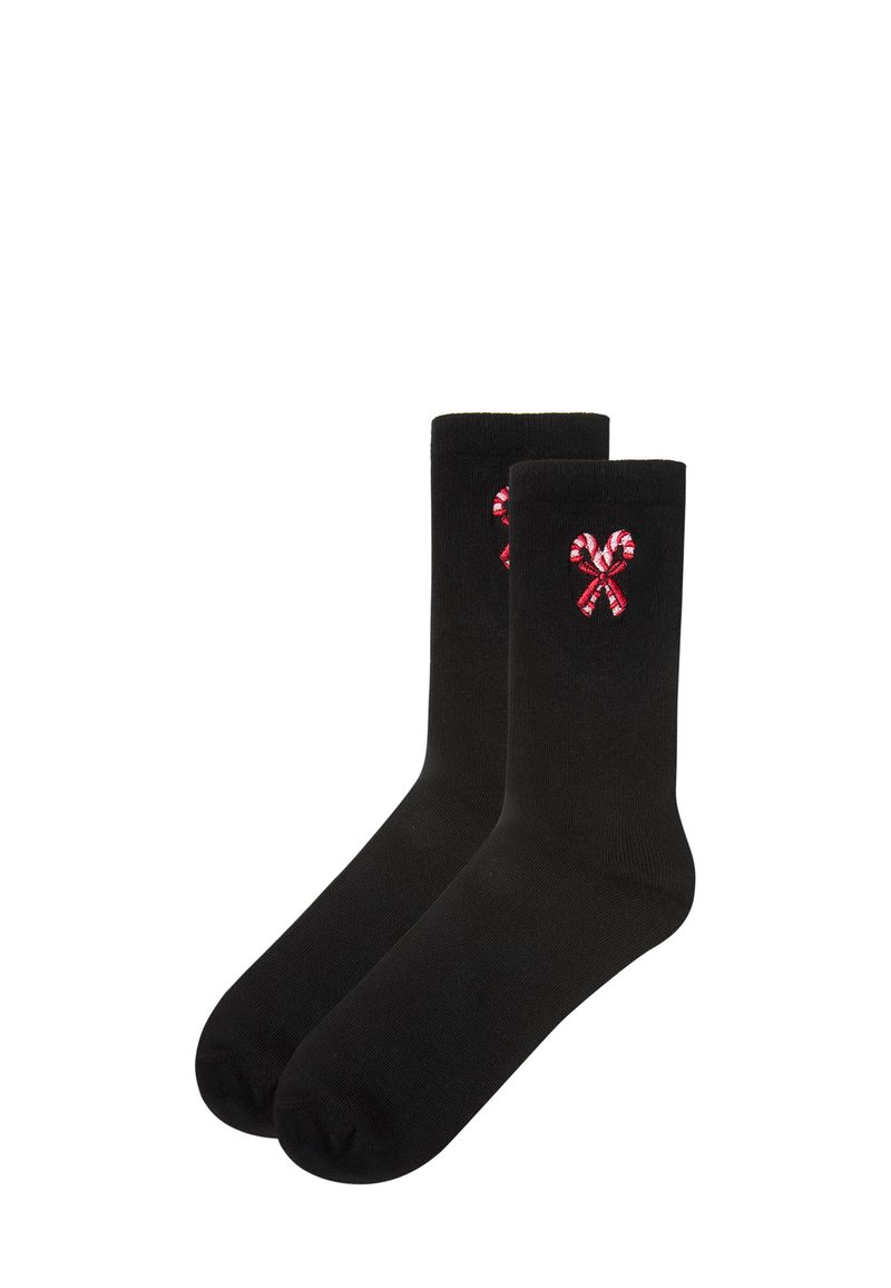 Schwarze Socken mit gerippter Textur, die auf der Außenseite jeder Socke rot-weiße Zuckerstangen-Stickerei zeigen.
