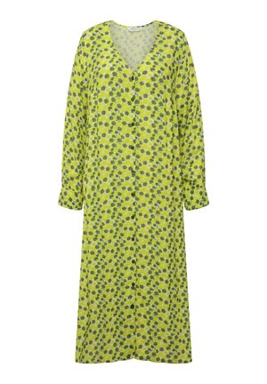 Pitkä nappilukkopuku kirkkaassa keltavihreässä, jossa on vihreä-valkoinen kukkakuosi. Puvussa on V-mallinen kaulus ja pitkät hihat.