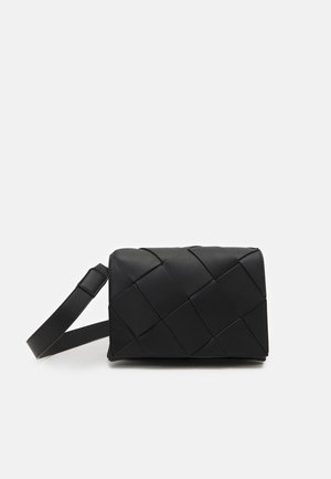 Sort rektangulær crossbody-taske med bred justerbar rem og tekstureret gittermønster på forsiden.