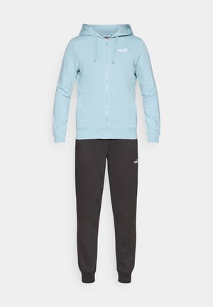 Light blue zip-up hoodie with drawstrings and white logo, paired with dark gray sweatpants, both made from soft, textured fabric.