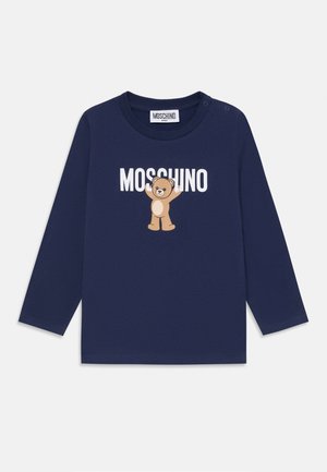 Long-sleeve navy t-shirt in soft cotton, featuring a brown bear graphic and "MOSCHINO" text. Snap closure at shoulder for easy wear.