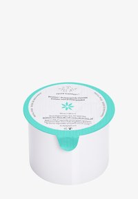 White cylindrical cream container with a teal lid; label details product name, volume, and a floral graphic. Smooth texture.