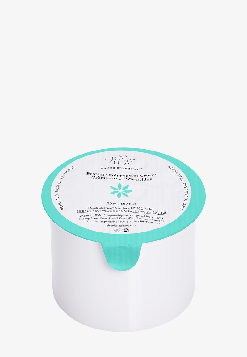 White cylindrical cream container with a teal lid; label details product name, volume, and a floral graphic. Smooth texture.