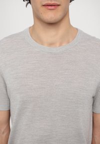Light grey short-sleeve crewneck t-shirt made of soft fabric, featuring a smooth texture and minimal design with no visible patterns or accents.