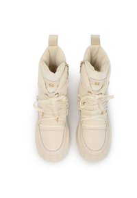 Sneakers alti color crema, con parte superiore imbottita, chiusure a lacci, dettagli in hardware dorato e suola testurizzata. Due zip laterali per un accesso facile.