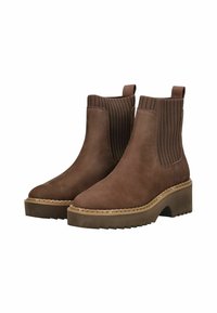 Bruine suède enkellaarzen met ribbel elastic goring. Dikke plateauzool met gekartelde randen en bovenste lussen voor eenvoudig aan- en uittrekken.