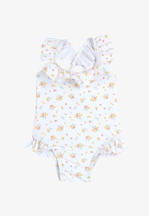 Maillot de bain une pièce floral blanc, doté d'un col à volants et de détails latéraux, avec un mélange de motifs jaunes, roses et verts.