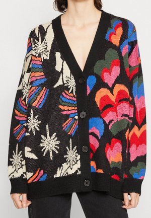 Knit cardigan featuring a V-neck, black background, and multicolored heart and floral patterns. Five black buttons down the front.
