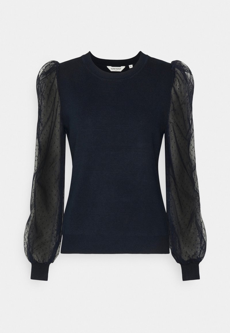 Pull bleu marine avec manches bouffantes noires transparentes et motif subtil à pois, présenté sur fond blanc uni.