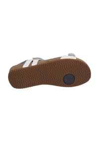 Platform sandal with a cork sole and a textured rubber bottom. Features gray fabric straps and white plastic accents.
