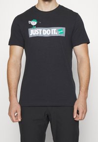 Nike Golf Triko s potiskem - black