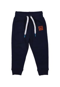 Navyblaue Jogginghose aus weichem Stoff. Mit ribbelten Bündchen, einem Kordelzug mit mehrfarbigem Muster und einem braunen Logo-Patch auf der Vorderseite.