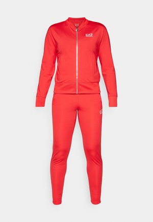 Red tracksuit made of smooth fabric; features a zip-up bomber jacket and fitted pants. Both pieces display the EA7 logo in white.