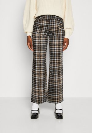 Brede geruite broek met een mix van zwart, beige en wit. Gemaakt van een gestructureerde stof met grote ruitenpatronen.