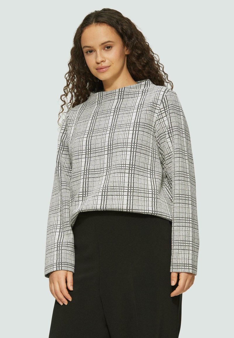 Gekürzter Pullover im schwarz-weißen Karo-Muster, mit rundem Ausschnitt und langen Ärmeln, aus einem glatten Material.