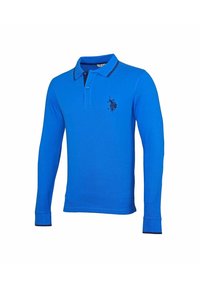 Långärmad polotröja i ljusblå bomull med en kontrasterande marinblå krage. Har en broderad svart logotyp på vänster bröst.