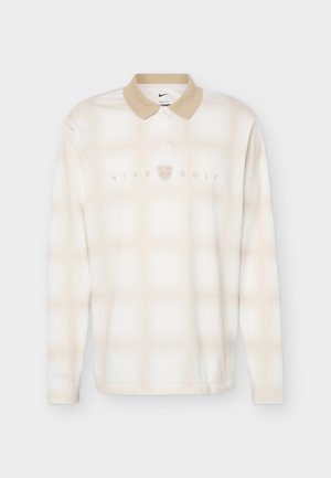 Μακρυμάνικο μπεζ και λευκό καρό πόλο Nike Golf με λαιμόκοψη σε ταμπά χρώμα και λογότυπο τοποθετημένο στο κέντρο του στήθους.