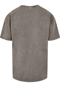 Grau übergroßes T-Shirt aus Baumwolle mit einer strukturierten, verblassten Optik. Mit kurzen Ärmeln und Rundhalsausschnitt.
