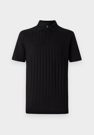 Polo shirt nera a maniche corte, con un motivo a diamante testurizzato e colletto classico. Realizzata in tessuto morbido, presenta un'apertura con bottoni.
