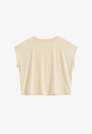 Luźna bluzka z krótkim rękawem i okrągłym dekoltem w jasnobeżowym kolorze, o pudełkowatym, oversize kroju i minimalistycznym wykończeniu.