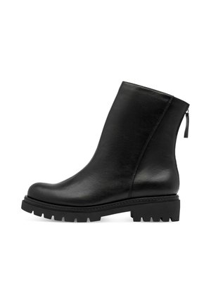 Black leather ankle boot with chunky lug sole and back zipper closure, shown in profile on a white background.