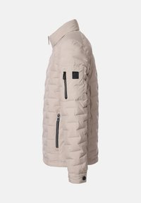 Beige gesteppte Jacke, seitlich gezeigt, mit hohem Kragen, Reißverschlusstaschen am Ärmel und an der Seite sowie geknöpftem Ärmelbund.