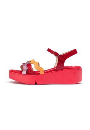 Sandalias de plataforma rojas con una superficie texturizada, que cuentan con tiras onduladas en varios colores en tonos de rojo, naranja y púrpura. Hebilla ajustable en el tobillo.