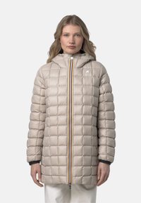 Giacca imbottita trapuntata beige con cappuccio, dotata di una zip frontale con una striscia multicolore e dettagli neri sui polsini. Tessuto liscio e lucido.