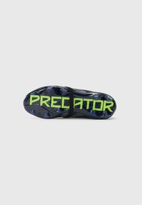 Black and neon green soccer cleat sole with studs, featuring the word "PREDATOR" printed in large neon green letters.