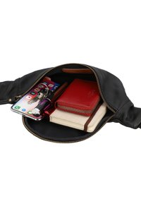 Schwarze Leder-Reißverschlusstasche, die ein Smartphone mit Schlüsseln, eine rote Brieftasche, ein Notizbuch mit Gummiband und zwei Lippenstifte enthält.