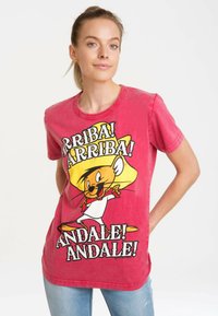 Red cotton t-shirt featuring a cartoon character with a wide-brimmed hat. Bold text reads "ARRIBA! ANDALE!" in contrasting colors.