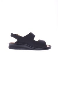 Black sandal with backstrap, open toe, and cutout details. Made of smooth material with visible stitching and a textured sole for grip.