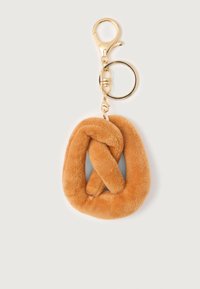 Soft brown plush pretzel keychain with gold metal ring and clasp on a white background.