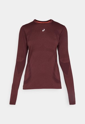 Long-sleeve athletic shirt in burgundy with a round neck and textured pattern. Features contrasting orange inner lining and logo on chest.