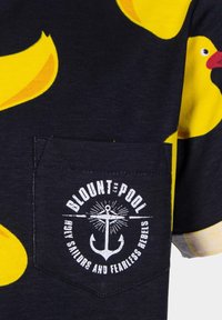 Navy cotton T-shirt with yellow rubber duck pattern, featuring a chest pocket with a white anchor graphic and text "BLOUNT & POOL."