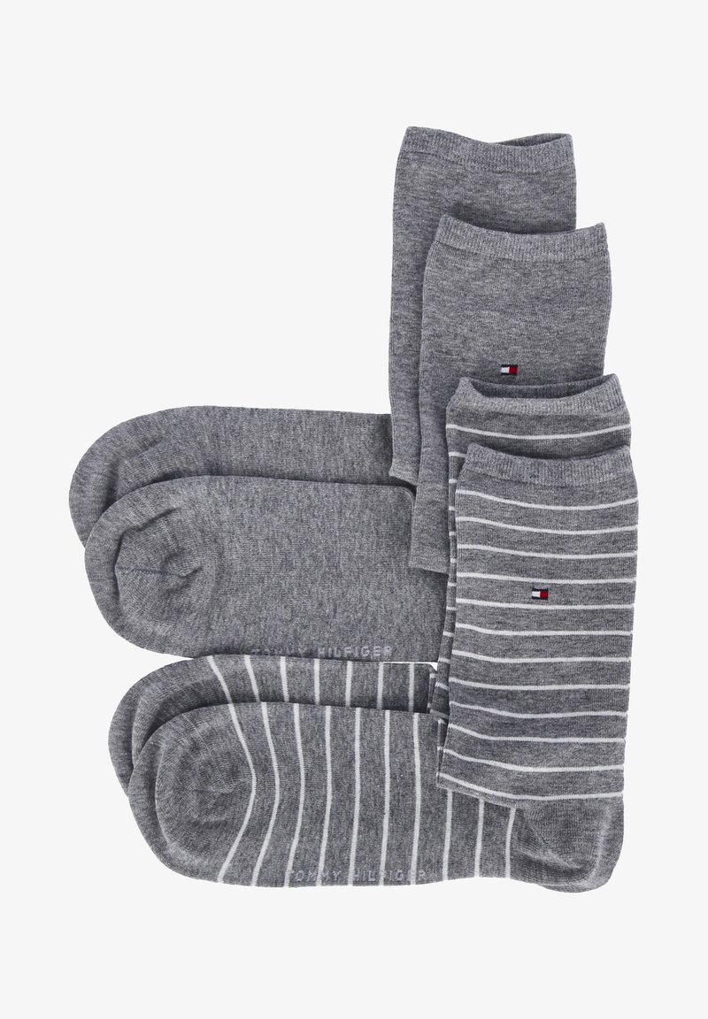 Set of gray socks, including two solid pairs and two striped pairs, made of soft fabric. Each pair features a Tom Hilfiger logo.