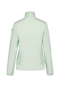 Mintgrön jacka med hög krage, slät textur och sidofickor; har en ren, minimalistisk design utan utsmyckningar.