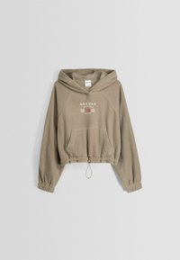 Värjätty beige fleecepusero, jossa on kiristysnyöri helmassa, joustavat hihansuut ja etutasku. "NORWAY"-teksti rinnassa.