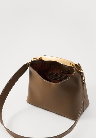 Brown leather handbag with a smooth finish, gold hardware, a single shoulder strap, and a spacious interior with a zippered pocket.