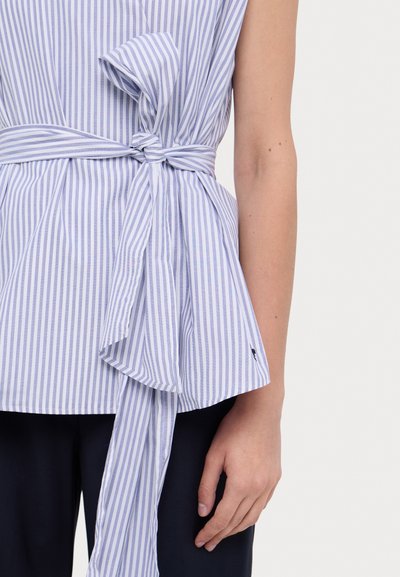 Blauw-wit gestreepte blouse met een strikdetail in de taille, korte mouwen en een uitlopende zoom. Heeft een soepele textuur en een subtiele merklogo.