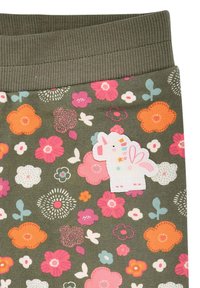 Olivgrüne Leggings mit einem floralen Muster in Pink, Orange, Weiß und Blau. Enthält ein weißes Einhorn-Patch mit pastellfarbenen Akzenten.