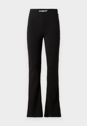 Black flared leggings with a smooth texture and elastic waistband featuring a white logo. Designed for comfort and flexibility.
