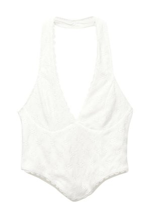 Valkoinen pitsibodysuit, jossa on syvä V-aukko, aaltoilevat reunat ja teksturoitu kukkakuosi. Bodysuitissa on leveät olkaimet ja istuva siluetti.