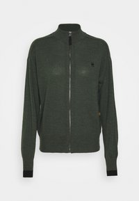 Groene zip-up trui van zachte breimateriaal, met een hoge kraag, lange mouwen en zwarte ribgebreide manchetten met een logo-detail.