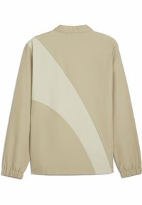 Beige langærmet skjorte med et geometrisk cremefarvet paneldesign, blødt stof, krave og elastiske manchetter.