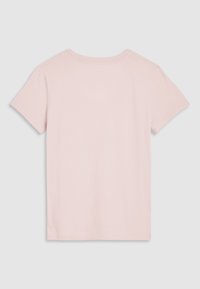 T-shirt uni rose clair à manches courtes montré de dos sur un fond gris clair.